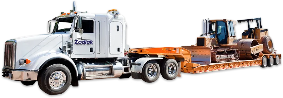 semi truck pulling heavy equipment on a low boy trailer